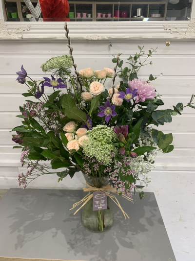 Wild Garden Harmony - A lush, garden-inspired arrangement. Presented in a clear glass vase with a rustic raffia tie